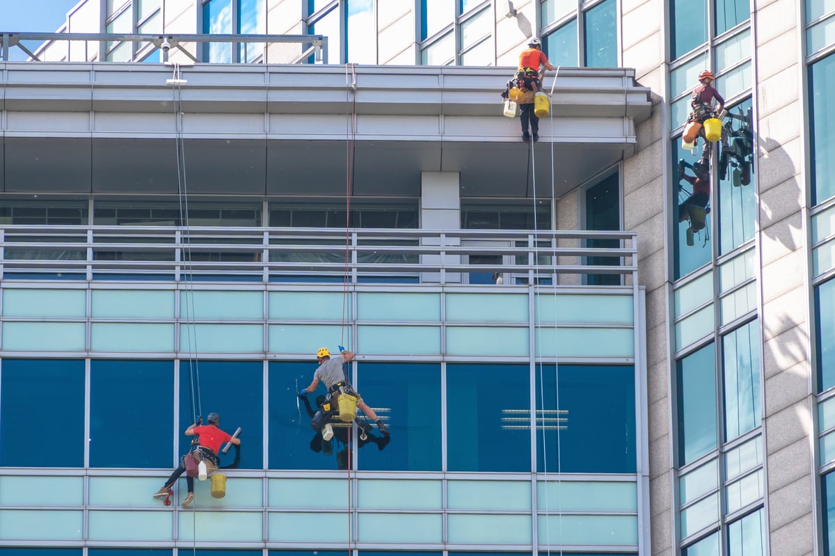 Professional window cleaning team working on building exterior